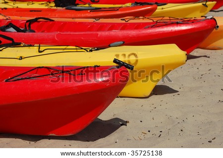 Ocean kayaks on a beach; Monterey, California
