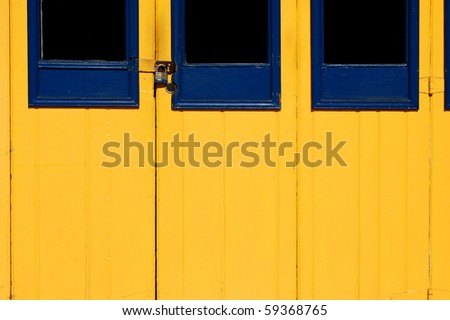 Locked blue and yellow wooden doors; \