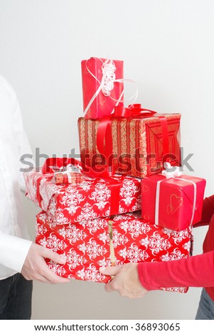A man giving christmas presents to a woman