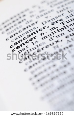 Close up of french dictionary at the word Cancer