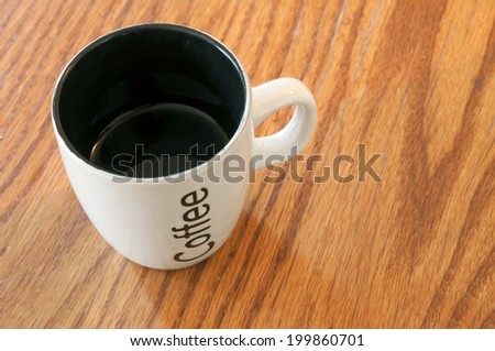 Black and white coffee cup on wooden table