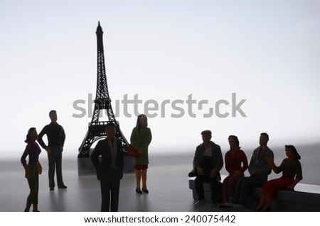 Scene of french people miniature figures in front of Paris Eiffel tower