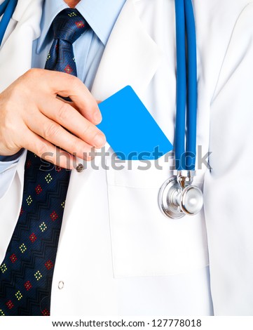 Closeup of business card in doctor\'s hand, and doc put the card in pocket