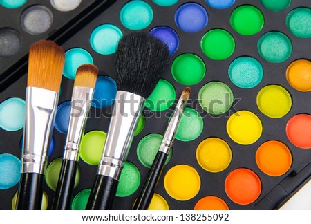 Different makeup brushes and make-up eye shadows