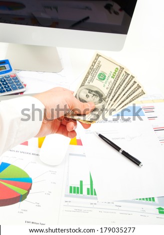 Accounting. Business man hands in office give money