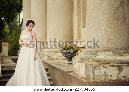 Beautiful bride on the stairs of the old church