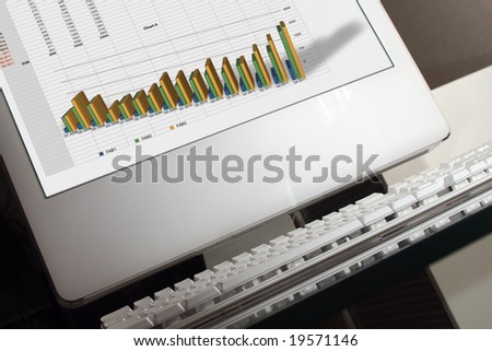 alternative look to the computer computer with diagram work on a screen, tilt view it is a bit blured