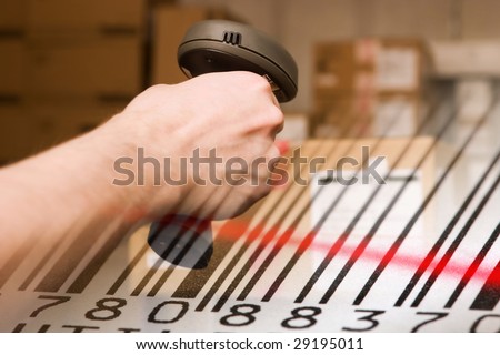 Barcode scanner and label with red laser beam. Warehouse concept.