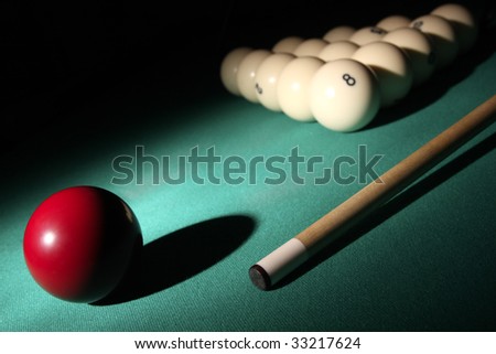 Pool balls and cue on light beam. Balls pyramid with number 8 ball on a background.