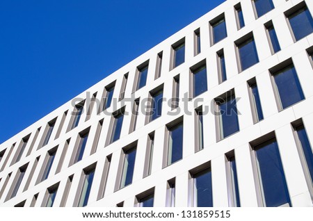 Modern apartment building against the blue sky. The symbol of wealth and success in life.