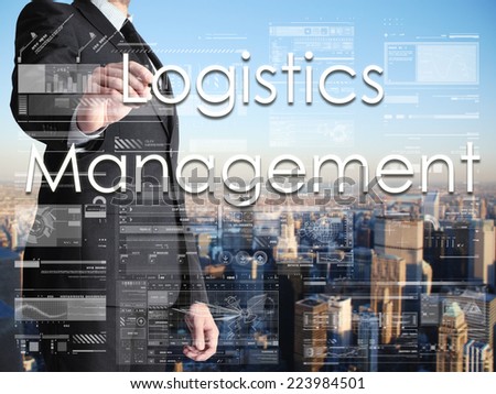businessman writing Logistics Management on transparent board with city in background
