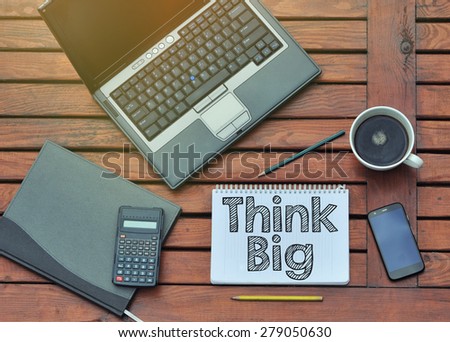 Notebook with text inside Think Big on table with coffee, mobile phone