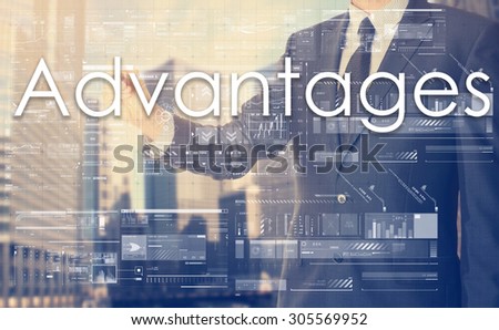 businessman writes on board text: Advantages - with sunset over the city in the background, the visible sun\'s rays in a picture are symbolizing the positive attitude