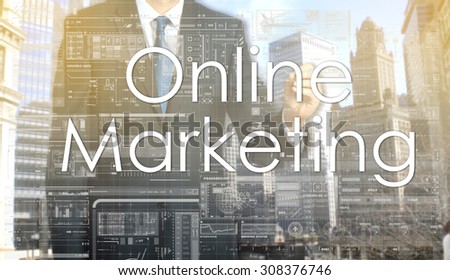 businessman writes on board text: Online Marketing - with sunset over the city in the background, the visible sun\'s rays in a picture are symbolizing the positive attitude
