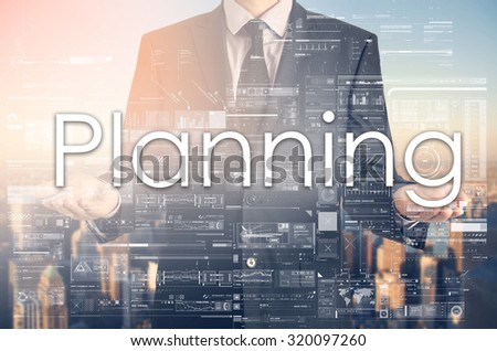 Businessman is presenting text:Planning