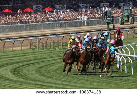 SARATOGA SPRINGS - JUL 21: Horses take the club house turn in race 7 on Jul 21, 2012 at Saratoga Race Course in Saratoga Springs, NY. Eventual winner is Edgar Prado (pink cap) and \