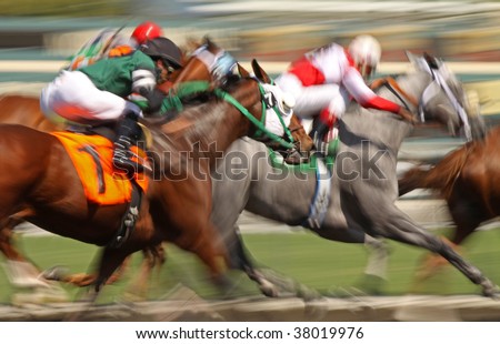 Slow shutter speed rendering of racing horses and jockeys