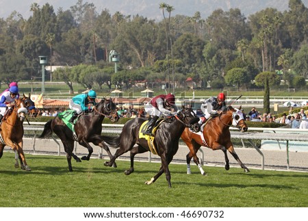 ARCADIA, CA - 30 JAN: Kuro (#4), with Michael Baze in the irons, moves up on Deputy Max en route to breaking his maiden at Santa Anita Park on Jan. 30, 2010 in Arcadia, CA.