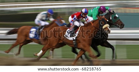ARCADIA, CA - JAN 1: A trio of jockeys surges down the homestretch in the first race at Santa Anita Park on New Year\'s Day, Jan 1, 2011 in Arcadia, CA.