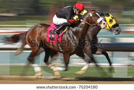 ARCADIA, CA - JAN 29: Two jockeys battle for the lead in a maiden claiming race at Santa Anita Park on Jan 29, 2011 in Arcadia, CA.