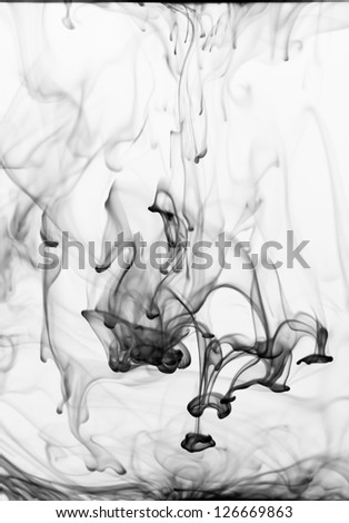 Ink flowing in water creating a black and white abstract