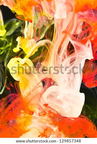 Vibrant background of red, white and orange ink dye in water, macro.