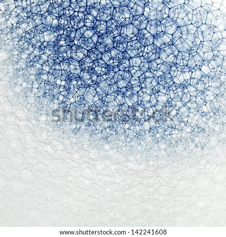 Blue dye flows over the  surface of the bubbles, accenting the geometric shapes formed.