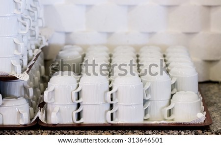 Set of white coffee cups on the tray in the hotel restaurant