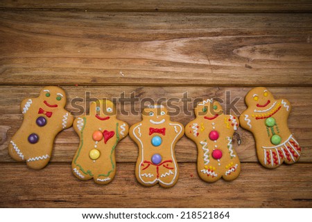 Home made gingerbread man decorating for Christmas on wooden background