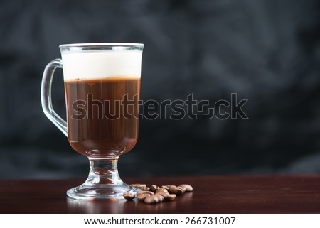 traditional strong irish coffee on wooden bar with coffee beans
