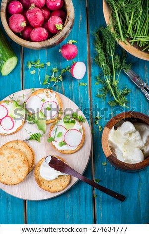 Healthy snacks,crackers with cottage cheese and fresh vegetables and herbs