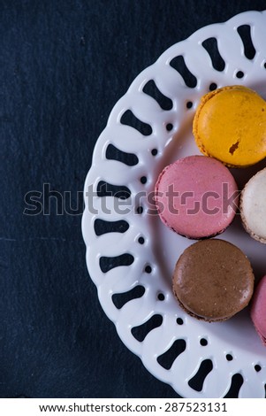 Colorful macaroons on serving plate, overhead
