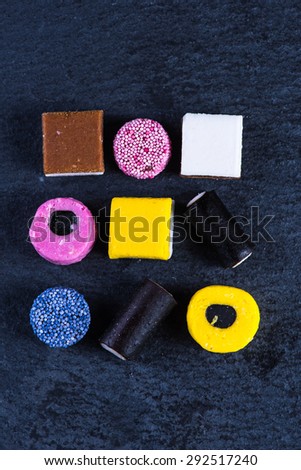 Liquorice candy, mixed colors vibrant background, from above