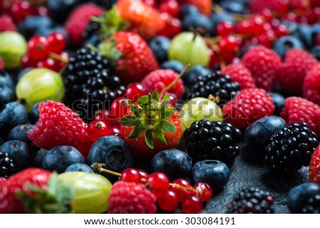 Mixed fresh ripe berries, food background from above