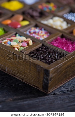 close view on sugar decoration in wooden rustic box