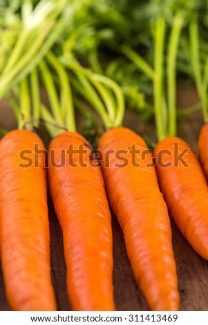 food background, farm fresh vibrant carrots on wooden table