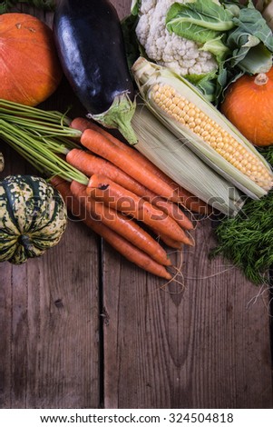Autumn market fresh vegetables and flowers on wooden table