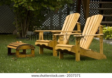 A pair of Adirondack chairs in the yard.  Known as Muskoka chairs in Canada.