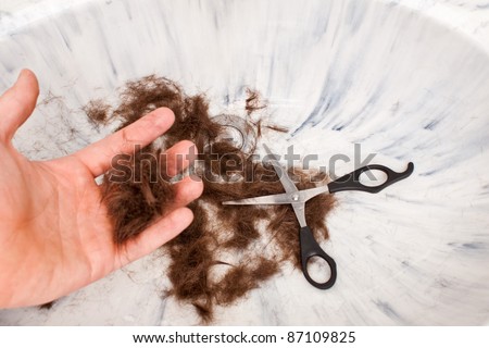 Hand holding hair after a self haircut