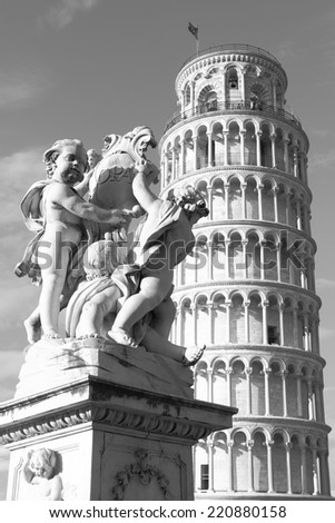 The Leaning Tower of Pisa and La Fontana dei Putti Statue, Italy. Black and white image