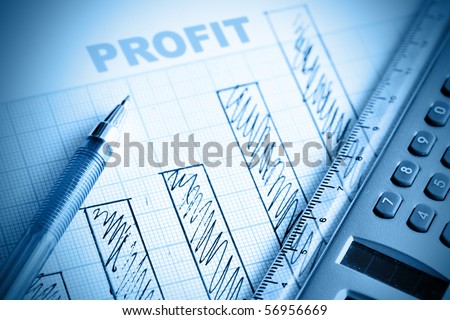 Profit bar chart, pen and calculator. Shallow DOF!