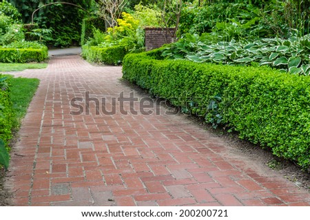 Brick pathways inside a large planted garden