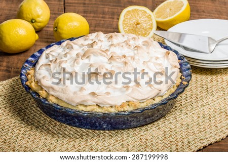 Homemade lemon meringue pie with cut lemon fruit