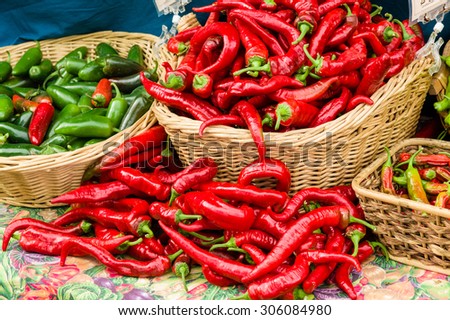 Red hot peppers in baskets displayed at the farm market