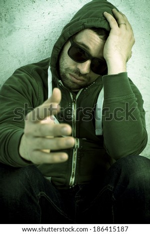Worried man who stretches out his hand