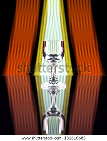 Glass of alcohol on disco background, party atmosphere