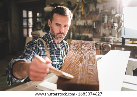 Image, Stock Photo Craftsman applying varnish to wood jalousie using airbrush in carpentry workshop