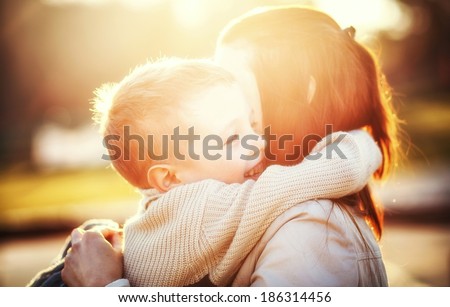 Mother hugging her child during walk in the park