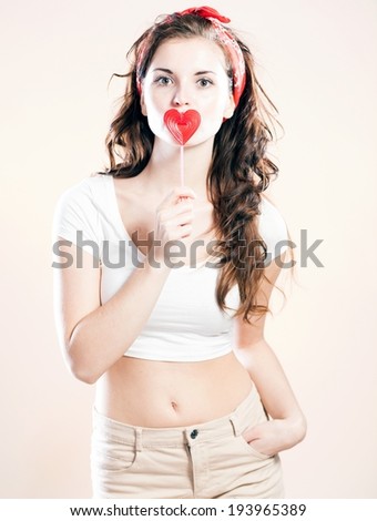 Pin up girl with lollipop in shape of heart