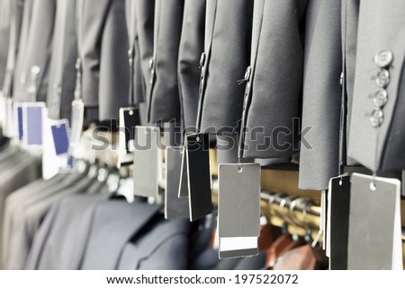 Row of elegant suits jacket on hangers in apparel store